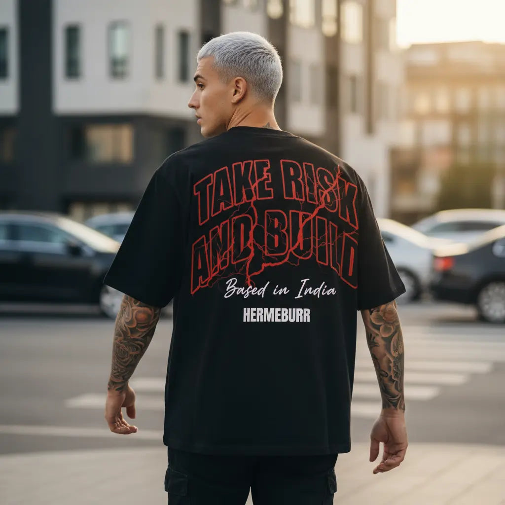 Candid streetwear photo of model wearing Hermeburr “Take Risk and Build” T-shirt, cinematic golden hour lighting, luxury oversized fit.
